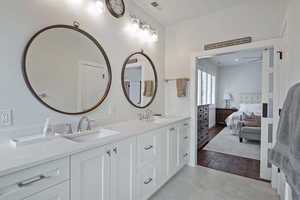 Bathroom featuring ceiling fan, vanity, and hardwood / wood-style flooring