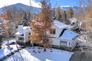 Snowy aerial view featuring a mountain view