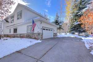 View of snowy exterior with a garage