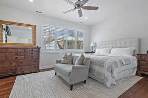 Bedroom featuring ceiling fan and dark wood-type flooring