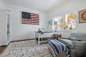 Office space with wooden walls and hardwood / wood-style floors