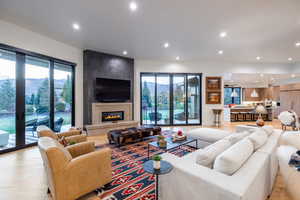 Living room featuring plenty of natural light, a fireplace, and light hardwood / wood-style flooring