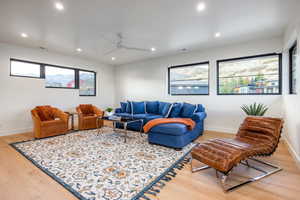 Living room featuring hardwood / wood-style flooring and ceiling fan