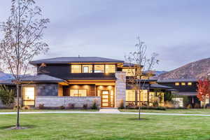 Prairie-style home featuring a mountain view and a front lawn