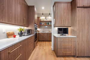 Kitchen featuring light wood-type flooring, double oven, and sink