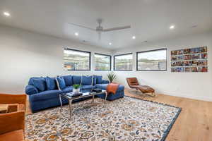 Living room featuring ceiling fan and light wood-type flooring