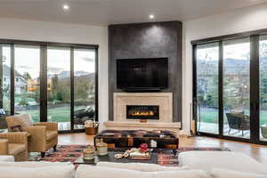 Living room featuring a large fireplace and light wood-type flooring