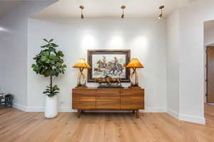 Corridor with light hardwood / wood-style floors