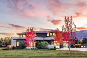 View of front facade featuring a lawn and a mountain view