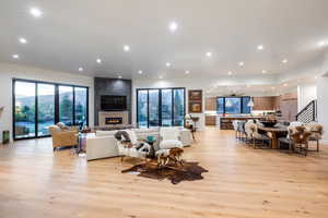 Living room featuring a large fireplace and light hardwood / wood-style flooring