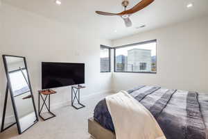 Bedroom with ceiling fan and carpet