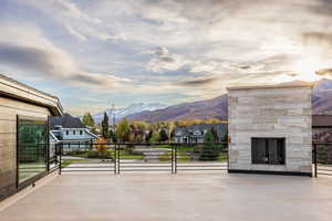 View of patio featuring a mountain view and an outdoor stone fireplace