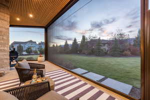 Patio terrace at dusk with an outdoor living space and a yard