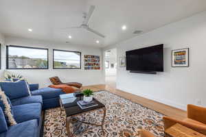 Living room featuring ceiling fan and wood-type flooring