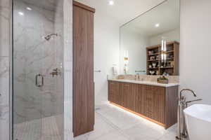 Bathroom featuring vanity and plus walk in shower