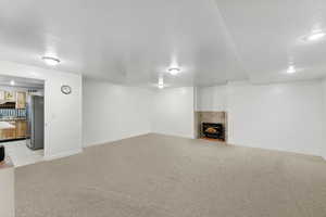 Unfurnished living room featuring light carpet