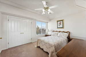 Bedroom featuring ceiling fan, light colored carpet, and a closet