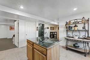 Kitchen with a kitchen island and light carpet