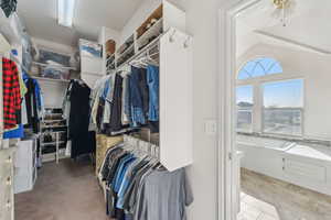 Walk in closet featuring ceiling fan and vaulted ceiling