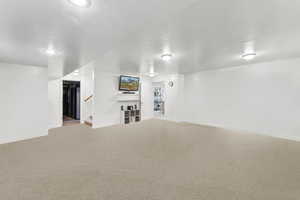 Unfurnished living room featuring carpet floors