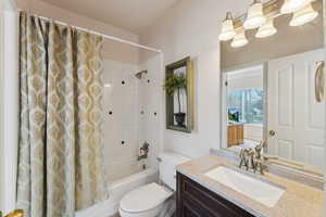 Full bathroom with shower / tub combo, vanity, and toilet