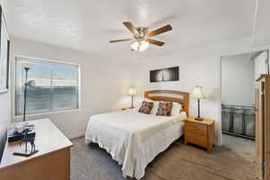 Bedroom featuring ceiling fan and carpet floors