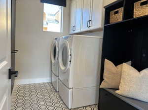 Laundry room with cabinets and washing machine and dryer. Image is of furnished model home - finishes will differ.