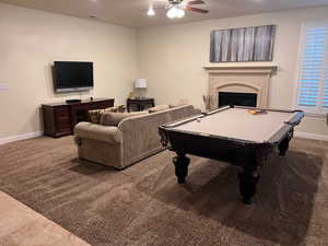 Recreation room featuring ceiling fan, light tile patterned flooring, and billiards