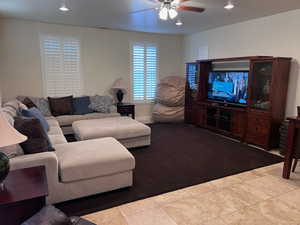 Tiled living room featuring ceiling fan