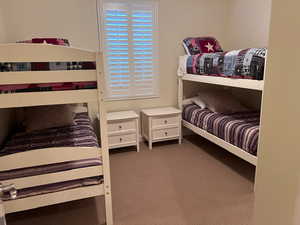 Bedroom featuring dark colored carpet