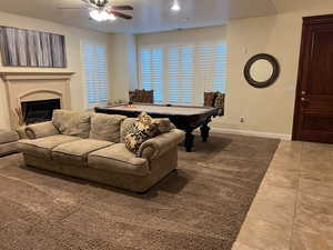 Tiled living room featuring ceiling fan