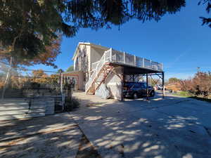 View of home's exterior featuring a carport and a wooden deck