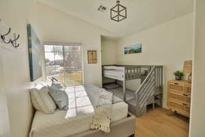 Bedroom featuring light hardwood / wood-style flooring and lofted ceiling