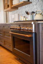 Room details with light hardwood / wood-style flooring and stainless steel stove