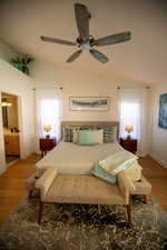 Bedroom featuring hardwood / wood-style flooring, multiple windows, and ceiling fan