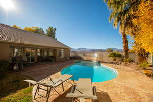 View of pool featuring a mountain view, a grill, a patio area, and a diving board