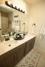 Bathroom with tile patterned floors, vanity, and toilet