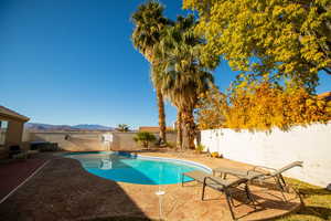 View of swimming pool featuring a mountain view and a patio