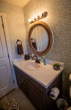 Bathroom featuring tile patterned flooring and vanity