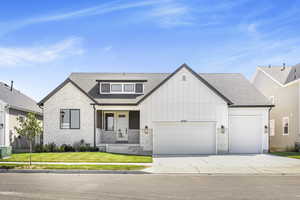 View of front of home featuring a garage and a front yard