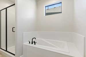 Bathroom featuring shower with separate bathtub