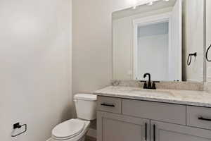 Bathroom featuring vanity and toilet