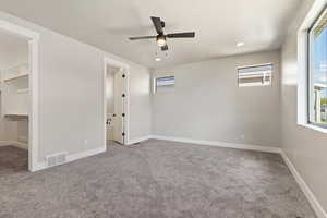 Unfurnished room with carpet flooring, ceiling fan, and a textured ceiling