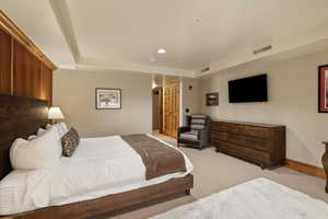 Bedroom featuring light carpet