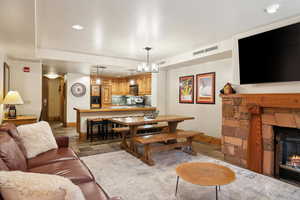 Living room featuring a fireplace and an inviting chandelier