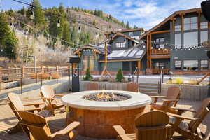 View of patio / terrace with a fire pit and a mountain view