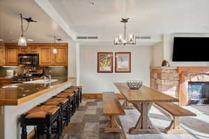 Dining space with sink and a notable chandelier