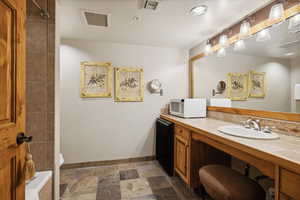 Bathroom featuring vanity and toilet