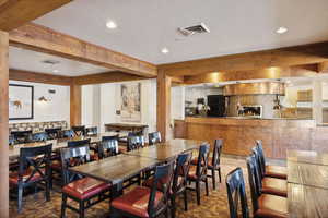 Dining room with beamed ceiling and a textured ceiling