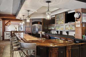 Bar with a textured ceiling and decorative light fixtures